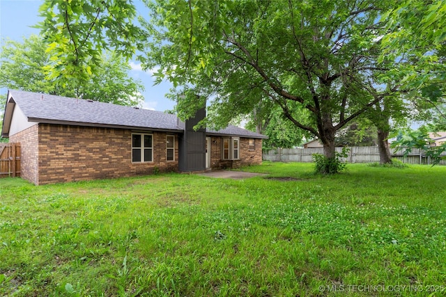 901 S Lions Ave, Broken Arrow, OK 74012 - rear view of property with brick siding and a shingled roof