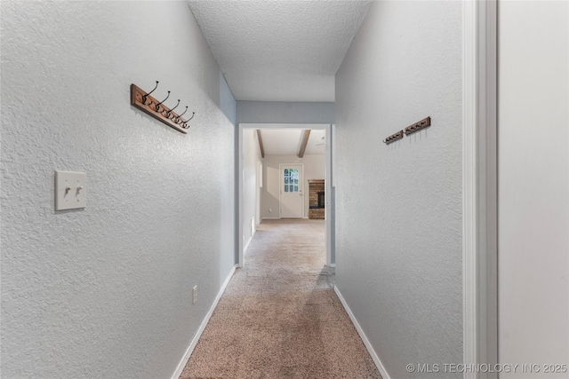 901 S Lions Ave, Broken Arrow, OK 74012 - hall featuring attic access, carpet, a textured wall, baseboards, and a textured ceiling