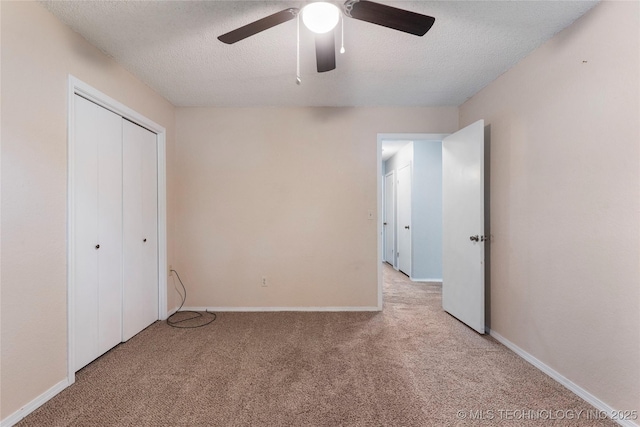 901 S Lions Ave, Broken Arrow, OK 74012 - unfurnished bedroom featuring carpet floors, a textured ceiling, a closet, baseboards, and a ceiling fan