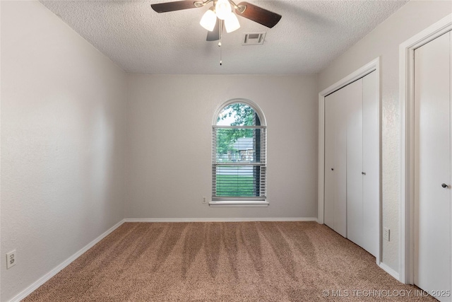 901 S Lions Ave, Broken Arrow, OK 74012 - unfurnished bedroom featuring a textured ceiling, carpet, a closet, ceiling fan, and baseboards