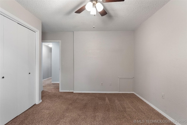 901 S Lions Ave, Broken Arrow, OK 74012 - unfurnished bedroom featuring carpet, a textured ceiling, a closet, and baseboards