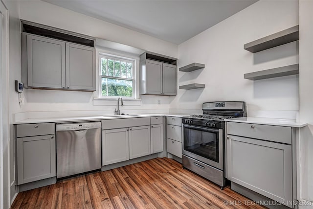 316 K St SW, Ardmore, OK 73401 - kitchen with stainless steel appliances, open shelves, gray cabinetry, and a sink