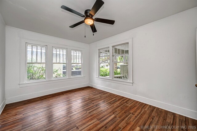 316 K St SW, Ardmore, OK 73401 - empty room with baseboards, dark wood finished floors, ceiling fan, and ornamental molding