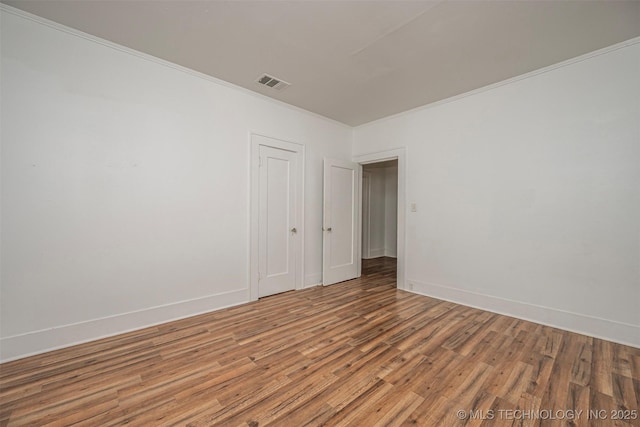316 K St SW, Ardmore, OK 73401 - spare room featuring light wood finished floors, ornamental molding, and baseboards