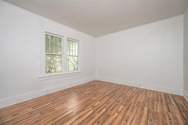 316 K St SW, Ardmore, OK 73401 - empty room with crown molding, wood finished floors, and baseboards