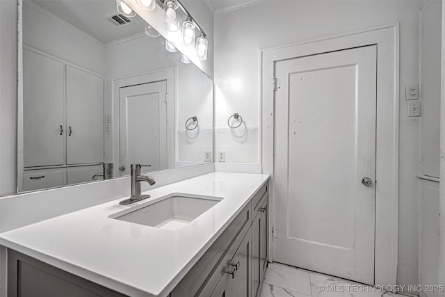 316 K St SW, Ardmore, OK 73401 - bathroom with marble look tiles, ornamental molding, and vanity
