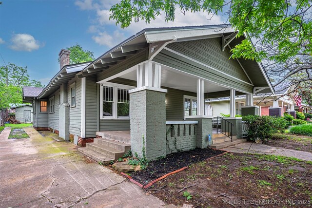 316 K St SW, Ardmore, OK 73401 - view of property exterior featuring covered porch, a chimney, and driveway