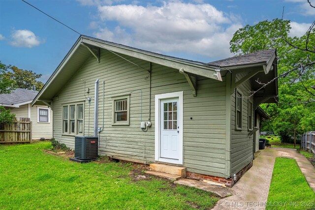 316 K St SW, Ardmore, OK 73401 - back of house featuring central AC and entry steps
