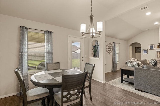 7506 E 87th Pl, Owasso, OK 74055 - dining room featuring arched walkways, dark wood-style floors, a chandelier, and lofted ceiling
