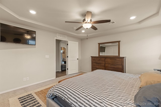 7506 E 87th Pl, Owasso, OK 74055 - bedroom featuring a raised ceiling, arched walkways, recessed lighting, carpet flooring, and ceiling fan