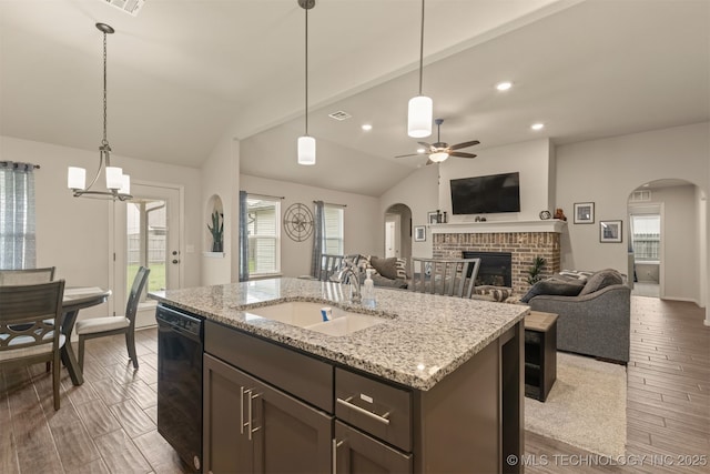 7506 E 87th Pl, Owasso, OK 74055 - kitchen with dishwasher, arched walkways, a ceiling fan, lofted ceiling, and a brick fireplace
