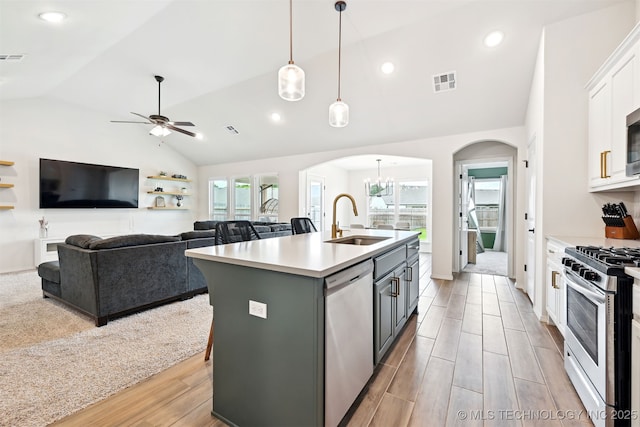 1816 E Winston St, Broken Arrow, OK 74011 - kitchen with arched walkways, a sink, appliances with stainless steel finishes, lofted ceiling, and white cabinetry