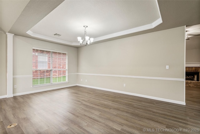 4309 W College St, Broken Arrow, OK 74012 - empty room with a raised ceiling, a chandelier, wood finished floors, baseboards, and crown molding