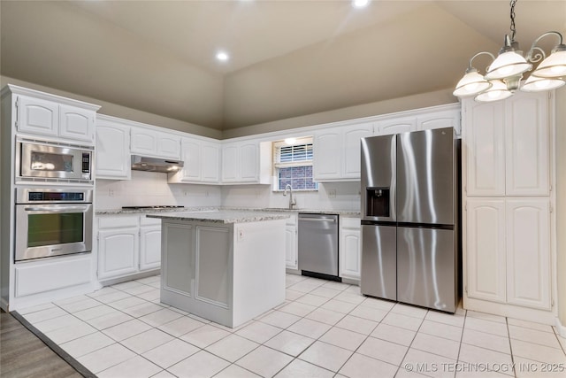 4309 W College St, Broken Arrow, OK 74012 - kitchen with stainless steel appliances, under cabinet range hood, a chandelier, white cabinetry, and recessed lighting