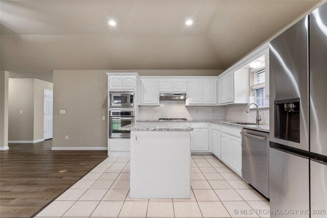 4309 W College St, Broken Arrow, OK 74012 - kitchen with stainless steel appliances, a sink, white cabinets, a center island, and vaulted ceiling
