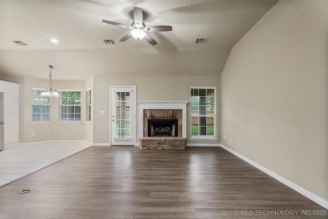 4309 W College St, Broken Arrow, OK 74012 - unfurnished living room featuring a ceiling fan, lofted ceiling, a fireplace, wood finished floors, and baseboards
