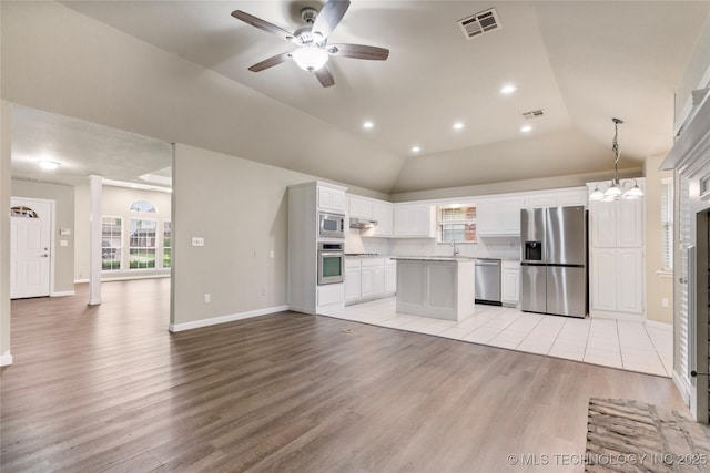 4309 W College St, Broken Arrow, OK 74012 - kitchen featuring appliances with stainless steel finishes, white cabinetry, light wood finished floors, open floor plan, and ceiling fan