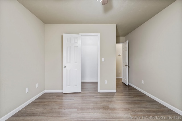 4309 W College St, Broken Arrow, OK 74012 - unfurnished bedroom with wood finished floors, baseboards, and ceiling fan