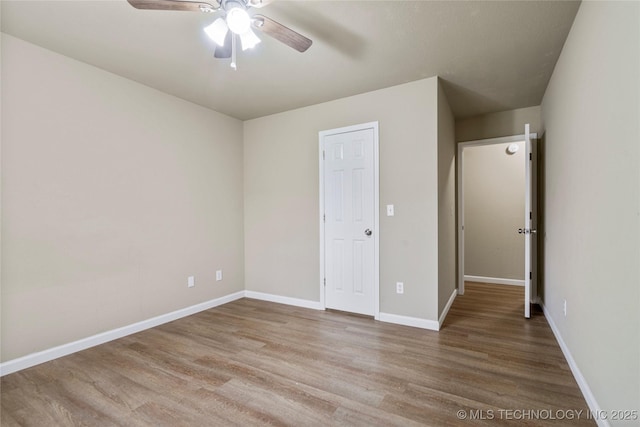 4309 W College St, Broken Arrow, OK 74012 - unfurnished bedroom featuring wood finished floors, baseboards, and ceiling fan