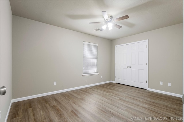 4309 W College St, Broken Arrow, OK 74012 - unfurnished bedroom with wood finished floors, baseboards, ceiling fan, and a closet