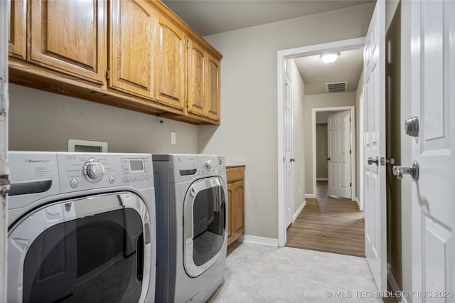 4309 W College St, Broken Arrow, OK 74012 - laundry area featuring separate washer and dryer, cabinet space, light tile patterned flooring, and baseboards