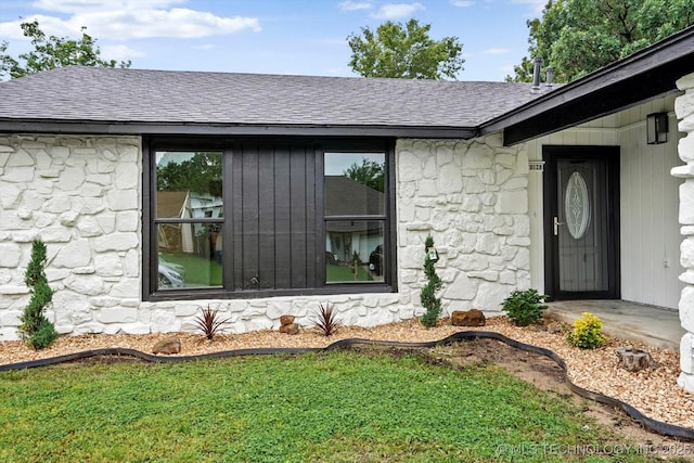 10128 E 34th St, Tulsa, OK 74146 - entrance to property featuring stone siding, a shingled roof, and a lawn