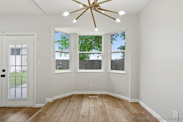 10128 E 34th St, Tulsa, OK 74146 - spare room featuring healthy amount of natural light, light wood-type flooring, and baseboards