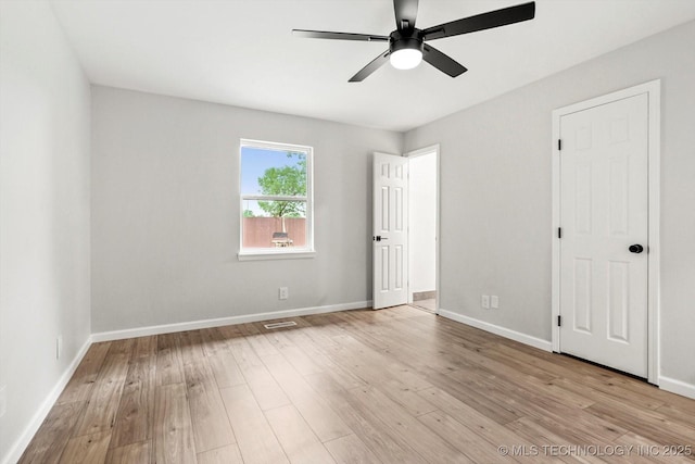 10128 E 34th St, Tulsa, OK 74146 - unfurnished bedroom featuring wood finished floors, baseboards, and ceiling fan