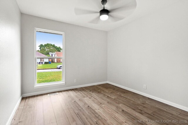 10128 E 34th St, Tulsa, OK 74146 - spare room with wood-type flooring, ceiling fan, and baseboards