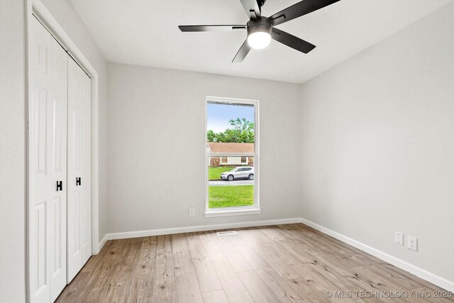 10128 E 34th St, Tulsa, OK 74146 - unfurnished bedroom with a closet, light wood-style floors, and baseboards