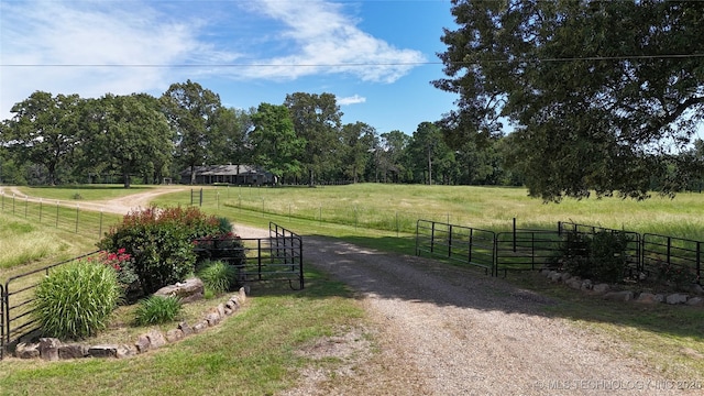 175 Johnson Rd, Broken Bow, OK 74728 - view of dirt / gravel driveway featuring a rural view, a gated entry, and a gate