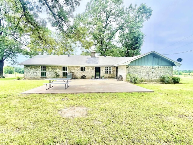175 Johnson Rd, Broken Bow, OK 74728 - rear view of property with a patio area, board and batten siding, stone siding, and a yard