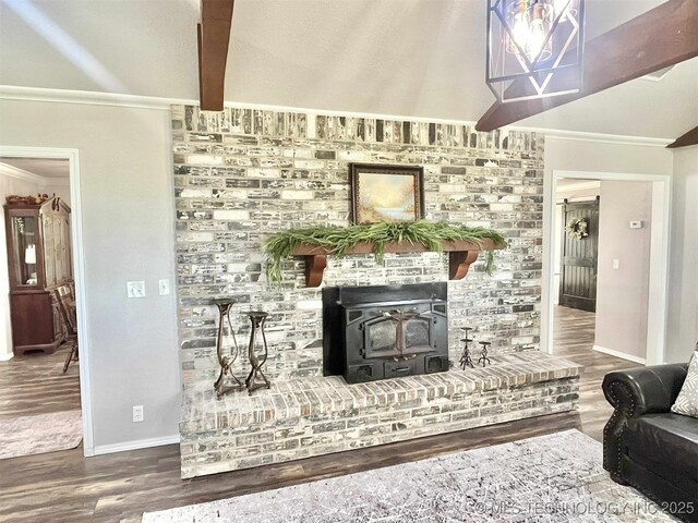 175 Johnson Rd, Broken Bow, OK 74728 - living room featuring wood finished floors, crown molding, baseboards, a wood stove, and beamed ceiling