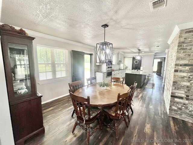 175 Johnson Rd, Broken Bow, OK 74728 - dining room featuring ornamental molding, dark wood finished floors, baseboards, and a textured ceiling