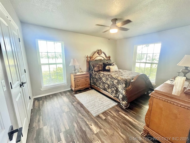 175 Johnson Rd, Broken Bow, OK 74728 - bedroom with a textured ceiling, wood finished floors, ceiling fan, and baseboards