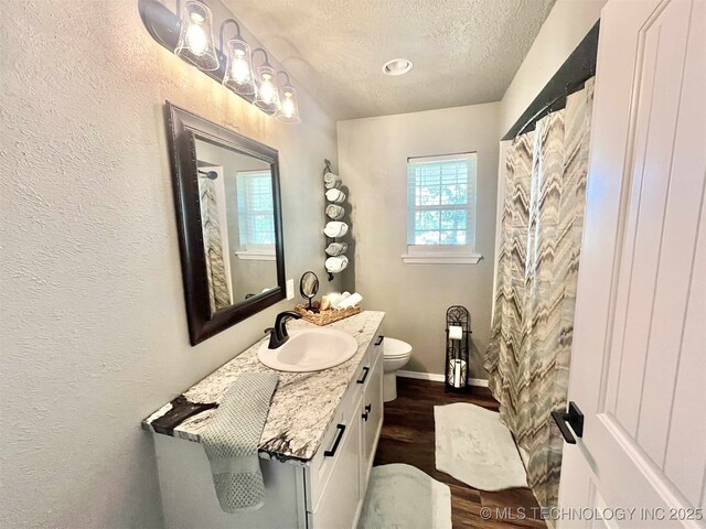 175 Johnson Rd, Broken Bow, OK 74728 - full bathroom with vanity, a textured ceiling, wood finished floors, toilet, and baseboards