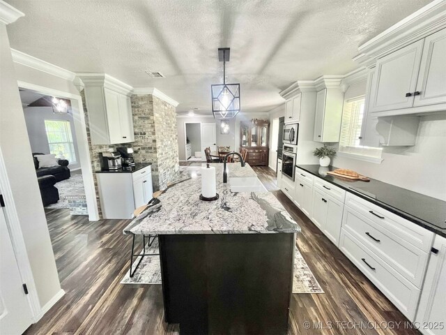 175 Johnson Rd, Broken Bow, OK 74728 - kitchen with a sink, appliances with stainless steel finishes, dark wood-style flooring, a textured ceiling, and ornamental molding