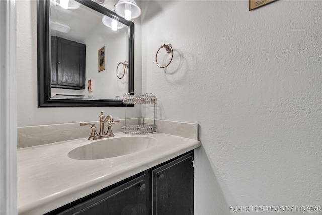 6356 S 80th E Ave Unit 25C, Tulsa, OK 74133 - bathroom featuring vanity and a textured wall