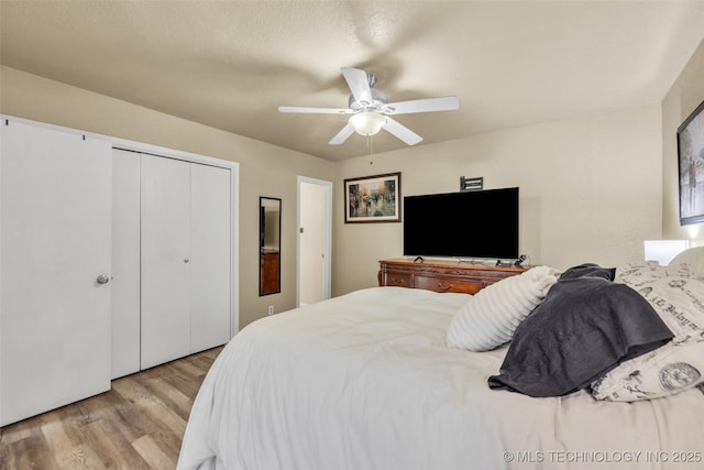 6356 S 80th E Ave Unit 25C, Tulsa, OK 74133 - bedroom with wood finished floors, a closet, and a ceiling fan