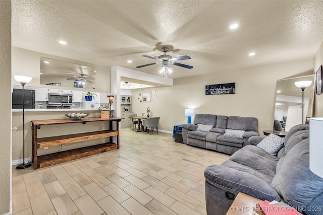 6356 S 80th E Ave Unit 25C, Tulsa, OK 74133 - living area featuring ceiling fan, a textured ceiling, baseboards, and recessed lighting