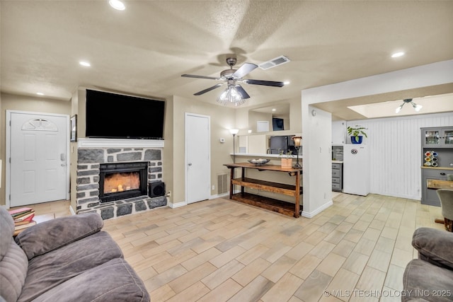6356 S 80th E Ave Unit 25C, Tulsa, OK 74133 - living area featuring a ceiling fan, a fireplace, baseboards, light wood finished floors, and recessed lighting