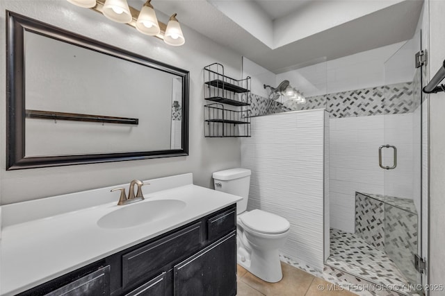 6356 S 80th E Ave Unit 25C, Tulsa, OK 74133 - full bathroom featuring toilet, a stall shower, tile patterned flooring, and vanity
