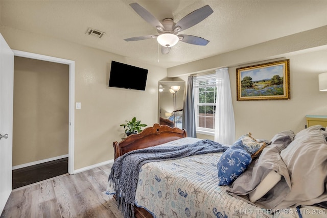 6356 S 80th E Ave Unit 25C, Tulsa, OK 74133 - bedroom with wood finished floors, baseboards, and a ceiling fan
