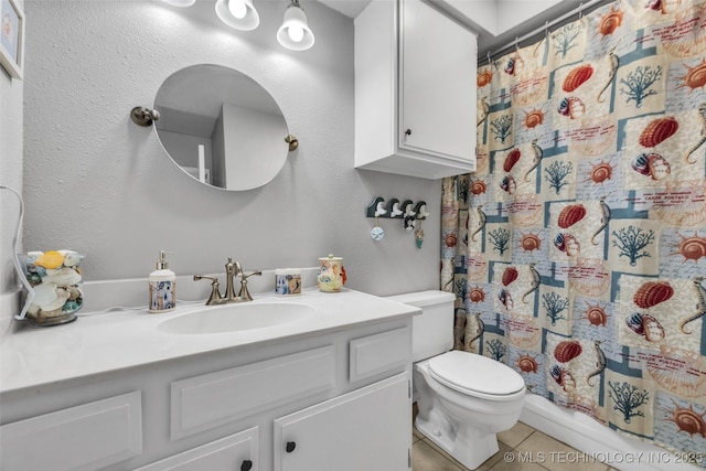 6356 S 80th E Ave Unit 25C, Tulsa, OK 74133 - full bathroom featuring tile patterned flooring, vanity, toilet, and a shower with curtain