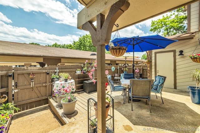 6356 S 80th E Ave Unit 25C, Tulsa, OK 74133 - view of patio featuring a gate and outdoor dining space