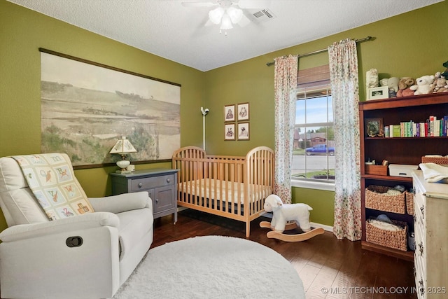 4407 W Lansing Pl, Broken Arrow, OK 74012 - bedroom featuring dark wood finished floors, baseboards, a nursery area, and ceiling fan