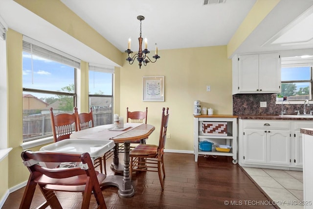 4407 W Lansing Pl, Broken Arrow, OK 74012 - dining room featuring a chandelier, baseboards, and light wood-style floors