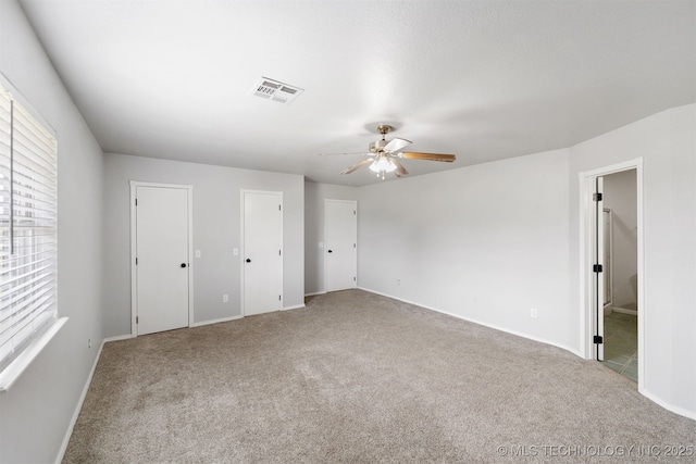 3160 E 406th Rd, Oologah, OK 74053 - unfurnished bedroom featuring carpet floors, baseboards, and two closets