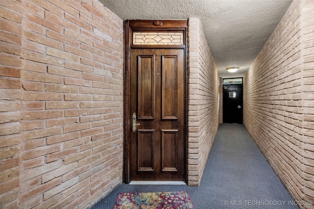 611 W 15th St Unit F1, Tulsa, OK 74127 - doorway to property with brick siding