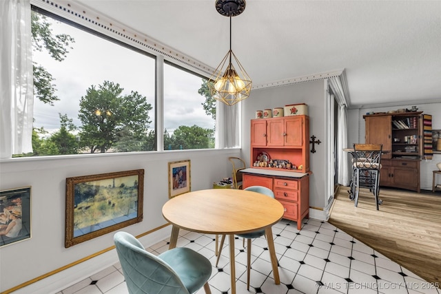 611 W 15th St Unit F1, Tulsa, OK 74127 - dining space with plenty of natural light, a chandelier, light floors, and baseboards